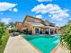 Large pool with patio and lush landscaping at 102 Via Duomo, New Smyrna Beach, FL 32169