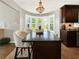 Island kitchen with granite countertops and dark wood cabinets at 102 Via Duomo, New Smyrna Beach, FL 32169