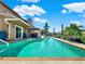 Inviting pool area with patio furniture and lush landscaping at 102 Via Duomo, New Smyrna Beach, FL 32169