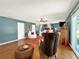 Spacious main bedroom with hardwood floors, a canopy bed, and sitting area at 102 Via Duomo, New Smyrna Beach, FL 32169