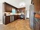 Modern kitchen with dark wood cabinets and tile flooring at 102 Via Duomo, New Smyrna Beach, FL 32169