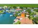 Aerial view of waterfront homes with private docks and lush landscaping at 102 Via Duomo, New Smyrna Beach, FL 32169