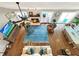 High-angle view of living room with hardwood floors and fireplace at 102 Via Duomo, New Smyrna Beach, FL 32169