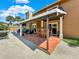 Spacious covered patio with outdoor furniture and a stone fireplace at 102 Via Duomo, New Smyrna Beach, FL 32169
