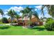 Landscaped side yard with lush tropical plants at 102 Via Duomo, New Smyrna Beach, FL 32169