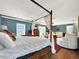Main bedroom with a canopy bed and access to a patio at 102 Via Duomo, New Smyrna Beach, FL 32169