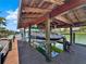Covered boat lift with additional seating and lighting at 102 Via Duomo, New Smyrna Beach, FL 32169