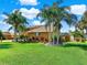 Beautiful house exterior with palm trees at 102 Via Duomo, New Smyrna Beach, FL 32169