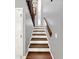 Modern staircase with wood and white accents at 102 Via Duomo, New Smyrna Beach, FL 32169