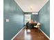 Cozy home office features wood floors, built-in desk, and calming blue walls at 102 Via Duomo, New Smyrna Beach, FL 32169