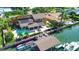 Waterfront property featuring a pool, dock, and boat slips at 102 Via Duomo, New Smyrna Beach, FL 32169