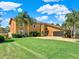 Luxury home exterior with palm trees and landscaping at 102 Via Duomo, New Smyrna Beach, FL 32169
