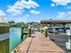 Wooden dock extending into the water with boat slips at 102 Via Duomo, New Smyrna Beach, FL 32169