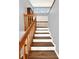 Wooden staircase with simple railing and gray walls at 102 Via Duomo, New Smyrna Beach, FL 32169