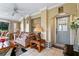 Living room with floral sofa and access to the kitchen at 636 Koala Ct, Poinciana, FL 34759