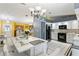 Bright kitchen features white cabinets, modern appliances, and a spacious island at 636 Koala Ct, Poinciana, FL 34759