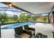 Enjoy this screened pool and patio area with seating at 636 Koala Ct, Poinciana, FL 34759