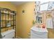 Small bathroom with single sink vanity, toilet and decorative accents at 636 Koala Ct, Poinciana, FL 34759