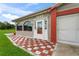 House entrance with red and white checkered tile at 636 Koala Ct, Poinciana, FL 34759