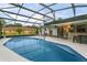 Large screened pool with patio furniture and backyard view at 636 Koala Ct, Poinciana, FL 34759