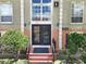 Condo building entrance with double doors and landscaping at 4100 Dijon Dr # 4100E, Orlando, FL 32808