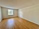 Spacious bedroom with wood-look flooring and a window providing natural light at 4100 Dijon Dr # 4100E, Orlando, FL 32808