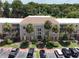 Condo building exterior with palm trees and parking at 4100 Dijon Dr # 4100E, Orlando, FL 32808