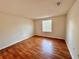 Well-lit bedroom featuring wood-look flooring and a large window at 4100 Dijon Dr # 4100E, Orlando, FL 32808