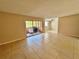 Bright living room with tile floors and sliding glass doors leading to a patio at 4100 Dijon Dr # 4100E, Orlando, FL 32808