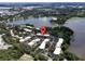 Aerial view of condo community near lake, showing location and landscaping at 4100 Dijon Dr # 4100E, Orlando, FL 32808