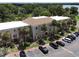 Aerial view of a condo building with parking and lake access at 4100 Dijon Dr # 4100E, Orlando, FL 32808