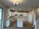 Modern kitchen with white cabinets and an island at 2645 Bittern Bnd, Saint Cloud, FL 34771