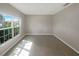 Bright and airy living room with large window and tile flooring at 920 Benjamin Trl, Davenport, FL 33837
