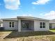 Rear view of house with patio and yard at 920 Benjamin Trl, Davenport, FL 33837
