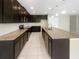 Modern kitchen with dark cabinets, granite countertops, and stainless steel appliances at 920 Benjamin Trl, Davenport, FL 33837