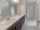 Double vanity bathroom with a large mirror and walk-in shower at 920 Benjamin Trl, Davenport, FL 33837