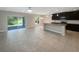 Open concept kitchen and living area with tile flooring and modern finishes at 920 Benjamin Trl, Davenport, FL 33837