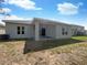 House exterior showcasing a covered patio and well-maintained yard at 920 Benjamin Trl, Davenport, FL 33837