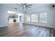 Gathering room with hardwood floors, kitchen view, and sliding door at 1301 Kintla Rd, Apopka, FL 32712