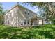 Two-story house with a beige exterior and a covered patio at 1301 Kintla Rd, Apopka, FL 32712