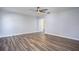 Bright bedroom with wood-look floors and access to closet at 1301 Kintla Rd, Apopka, FL 32712