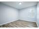 Simple bedroom with wood-look floors and window at 1301 Kintla Rd, Apopka, FL 32712