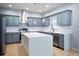 Modern kitchen with gray cabinets, quartz countertops, and island at 1301 Kintla Rd, Apopka, FL 32712