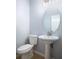 Clean bathroom with pedestal sink, oval mirror, and toilet at 1301 Kintla Rd, Apopka, FL 32712