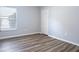 Bright bedroom with wood-look flooring and a spacious closet at 1301 Kintla Rd, Apopka, FL 32712