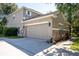 Attached garage with stone accents and a double door at 1301 Kintla Rd, Apopka, FL 32712