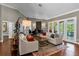 Elegant living area with hardwood floors, comfortable seating, and access to backyard at 2083 Biltmore Pt, Longwood, FL 32779