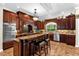 Spacious kitchen with dark wood cabinets and granite countertops at 2083 Biltmore Pt, Longwood, FL 32779