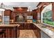 Gourmet kitchen featuring dark wood cabinetry and granite counters at 2083 Biltmore Pt, Longwood, FL 32779