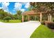 Covered entryway with a long driveway and lush green landscaping at 2083 Biltmore Pt, Longwood, FL 32779